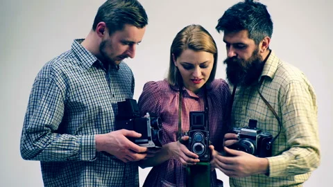 Concept of a photo case. Two guys and a girl in the process of creating a photo. Stock Footage 92117197
