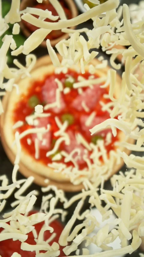 Concept of Pizza Preparation with Flying Cheese from Above. Stock Footage 298664875