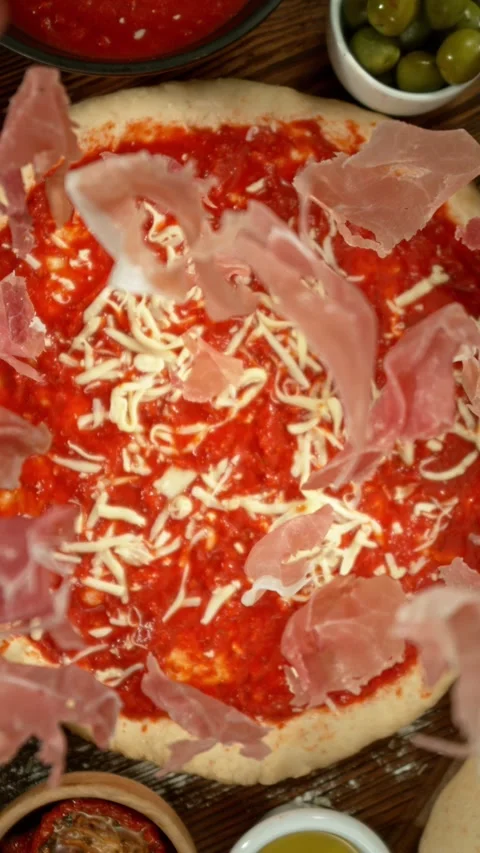 Concept of Pizza Preparation with Flying Ham from Above. Stock Footage 298665886
