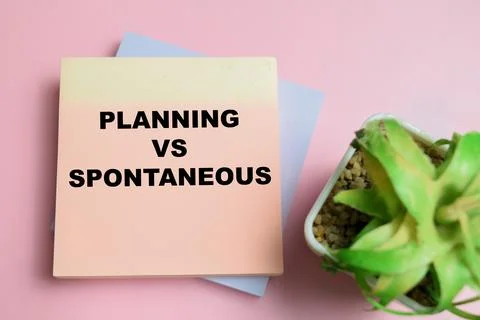 Concept of planning vs spontaneous write on sticky notes isolated on table. Stock Photos