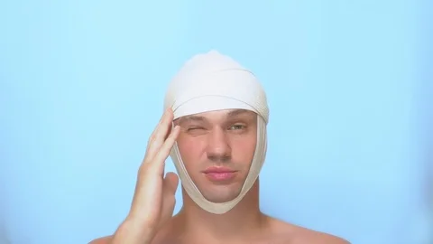 The concept of plastic surgery. a man touches his face after a plastic surgery Stock-Footage 112095478