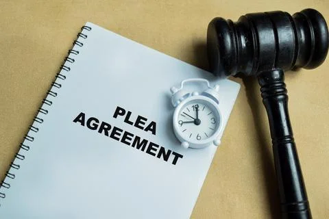 Concept of plea agreement with gavel write on book isolated on Wooden Table 스톡 사진