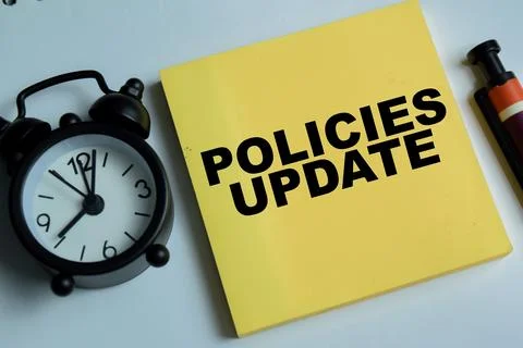Concept of policies update write on sticky notes isolated on Wooden Table. 写真素材