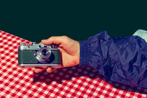 Concept of pop art photography. Using retro gadgets. Human hand holding photo Stock Photos