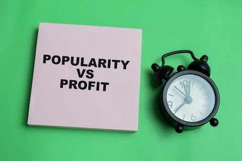 Concept of popularity vs profit write on sticky notes isolated on table. Stock Photos