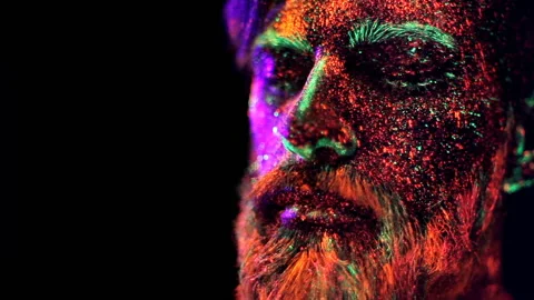Concept. Portrait of a bearded man. The man is painted in ultraviolet powder Stock Footage 110868801