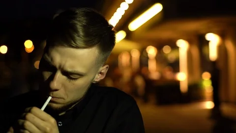 Concept portrait of handsome young man smoking cigarette during waiting for Stock Footage 117631332