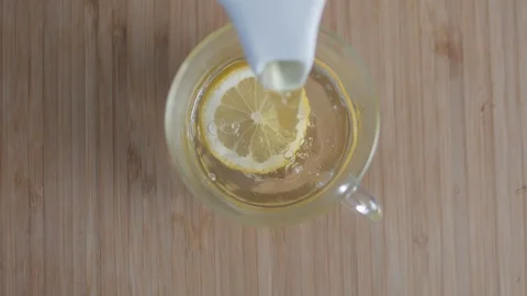 The concept is to pour green tea into a cup of lemon Stock Footage 127849200