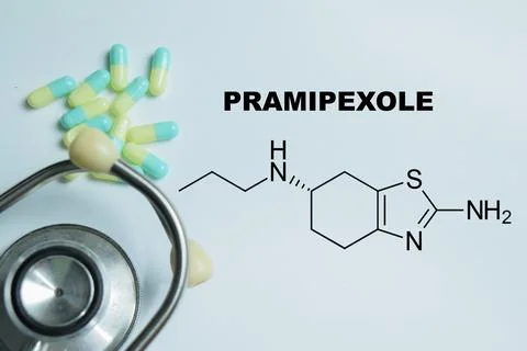 Concept of pramipexole write on book isolated on Wooden Table. Stock Photos