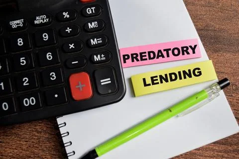 Concept of Predatory Lending write on sticky notes isolated on Wooden Table. Stock Photos