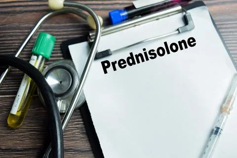 Concept of prednisolone write on clipboard isolated on Wooden Table. Stock Photos