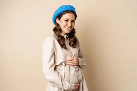 Concept of pregnancy and surrogacy. Young gentle and tender woman with big belly Stock Photos