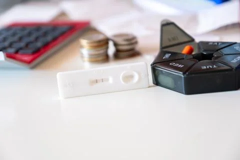 Concept of pregnancy test with supplements represents the costs of pregnanc.. Stock Photos