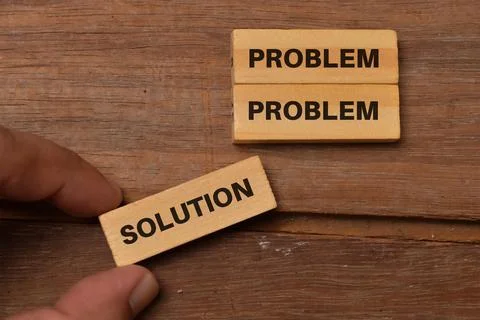 Concept of problem solving. Hand holding a wooden block with the word SOLUTIO Stock Photos