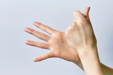 The concept of the process of washing hands using soap on a white background. Stock Photos