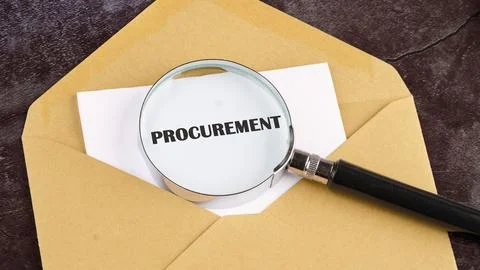 Concept of procurement. PROCUREMENT through a magnifying glass on a piece of  Stock Photos