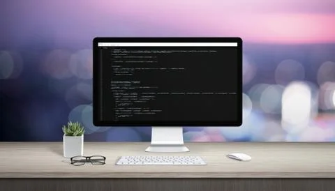 Concept of programming on a computer. Work desk with computer display and tex Foto stock