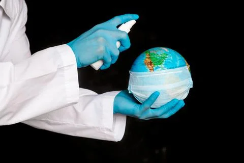 The concept is to protect the planet from coronavirus. splash the antiseptic on Stock Photos