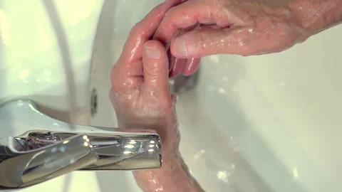 Concept of protecting the body from germs and viruses. Hand of old man that Stock Footage 130637799