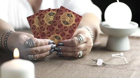 Concept of psychic advisor or ways of divination with cards. Stock Photos