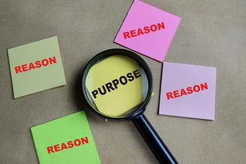 Concept of purpose and reason write on sticky notes isolated on Wooden Table. Foto stock