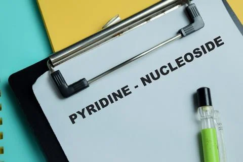Concept of pyridine - nucleoside write on clipboard isolated on Wooden Table. Stock Photos