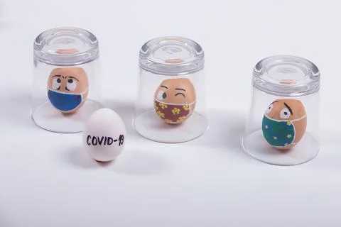 The concept of quarantine at Easter time. Easter  painted eggs in glass cups, Stock Photos