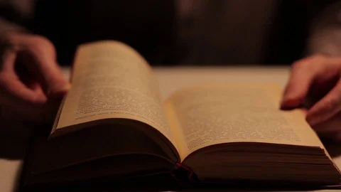 Concept: reading, books, bookmark. A man's hand holds the pages of the book. Stock Footage 72721398