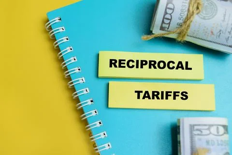 Concept of reciprocal tariffs write on sticky notes isolated on table. Stock Photos