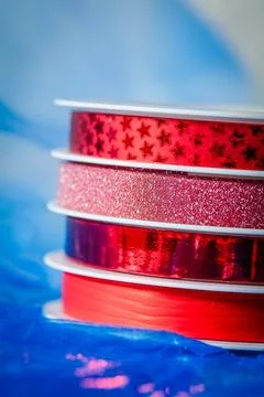 Concept of red gift ribbons on dispenser for festive packaging , celebratio.. Stock Photos