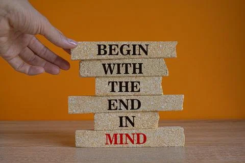 Concept red words Begin with the end in mind on brick blocks. Stock Photos