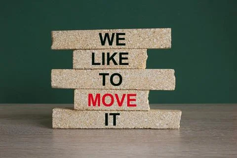 Concept red words We like to move it on brick blocks. Beautiful wooden table Stock Photos