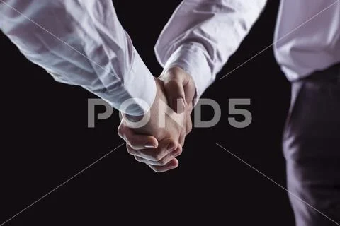 Concept of a reliable partnership: a close-up of handshake of business partners Stock Photos