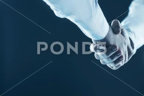 Concept of a reliable partnership: a close-up of handshake of business partners Stock Photos