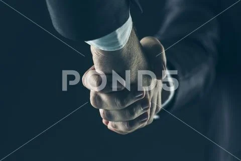 Concept of a reliable partnership: a close-up of handshake of business partners Stock Photos