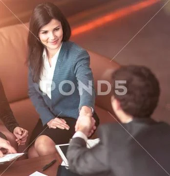 Concept of a reliable partnership - the lawyer and the client, shake hands after Stock Photos