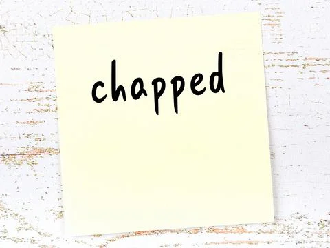 Concept of reminder about chapped. Yellow sticky sheet of paper on wooden wal Stock Illustration