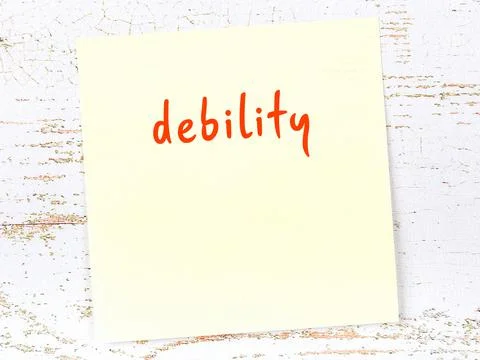 Concept of reminder about debility. Yellow sticky sheet of paper on wooden wa Stock Photos
