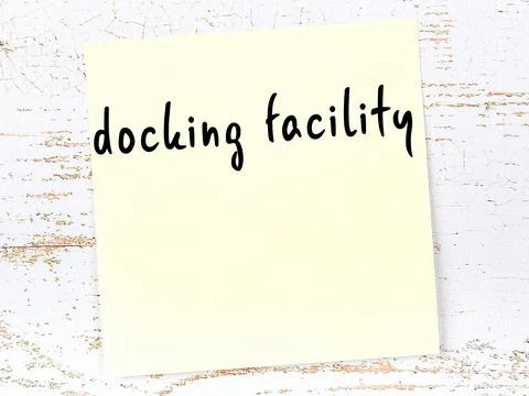 Concept of reminder about docking facility. Yellow sticky sheet of paper on w 写真素材