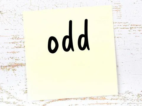 Concept of reminder about odd. Yellow sticky sheet of paper on wooden wall wi Stock Illustration