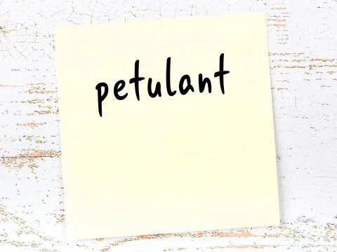 Concept of reminder about petulant. Yellow sticky sheet of paper on wooden wa Stock Photos