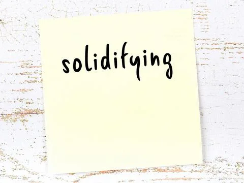 Concept of reminder about solidifying. Yellow sticky sheet of paper on wooden Stock Illustration
