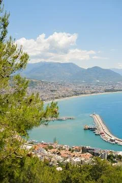 Concept of rest. Sea surface with clouds on horizon and costline town with Foto stock