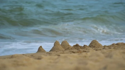 The concept of rest. Small sand castle on the background of sea waves. Stock Footage 106082241