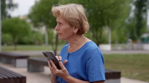 The concept of retirement, communication and the elderly. an elderly woman is Vídeo Stock 157797367