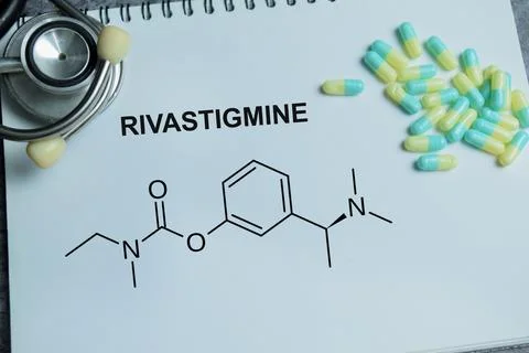Concept of rivastigmine medication write on book isolated on Wooden Table. Stock Photos