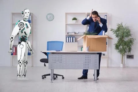 Concept of robots replacing humans in offices Stock Photos