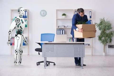 Concept of robots replacing humans in offices Stock Photos