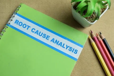 Concept of Root Cause Analysis write on book isolated on Wooden Table. Stock Photos