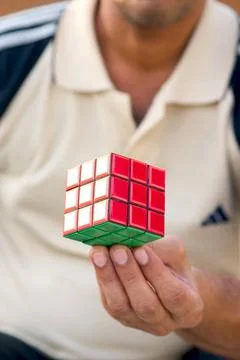 Concept ; Rubik puzzle cube game on hand MR 201 Copyright: xVxMishra/Dinod... Stock Photos